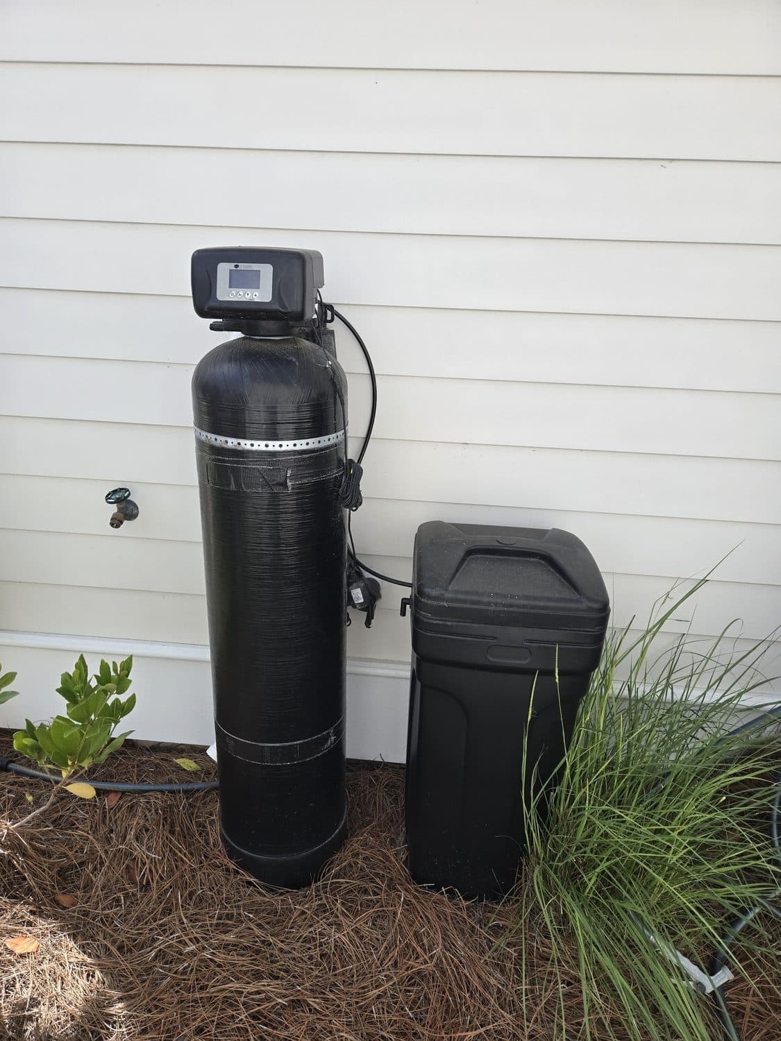 D'Pure whole-home water softener and brine tank installed outdoors